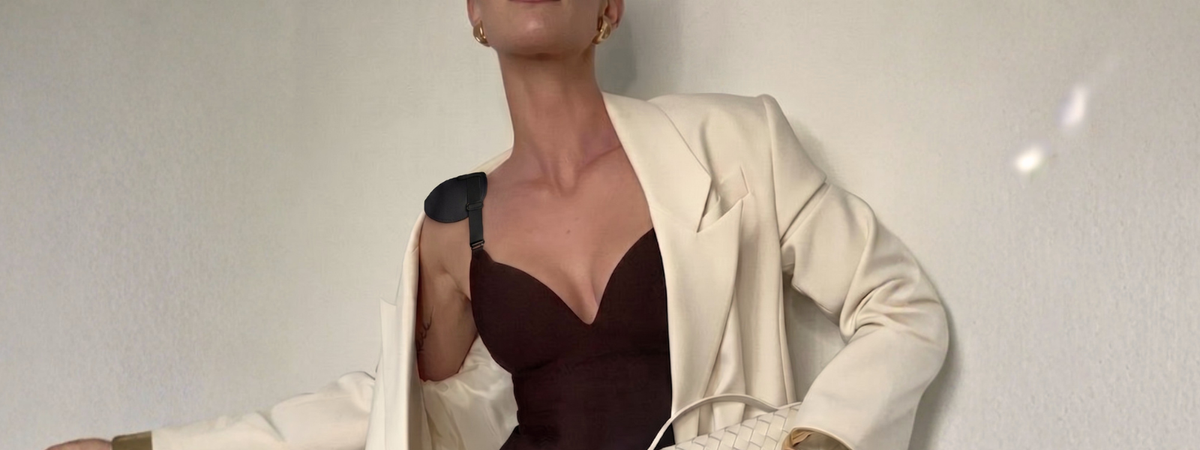 Black Gloris Shoulder Shaper worn under a white blazer as a removable shoulder pad